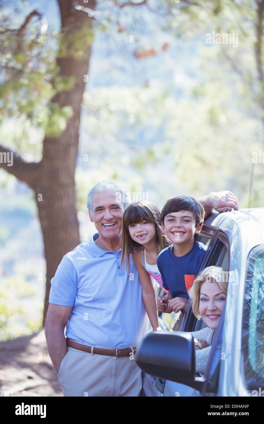 Portrait of happy family inside and outside car Stock Photo