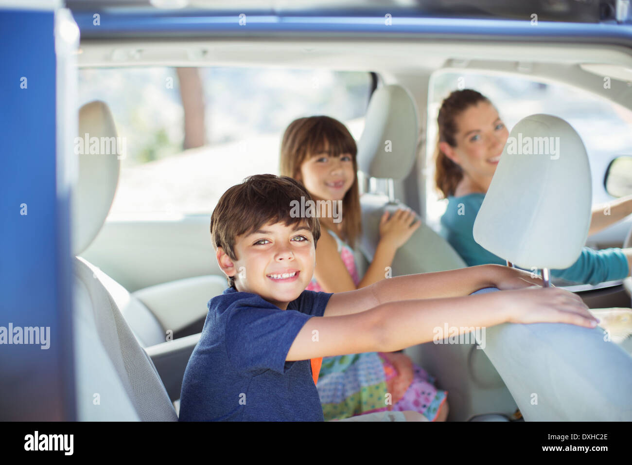 Portrait of happy family inside of car Stock Photo