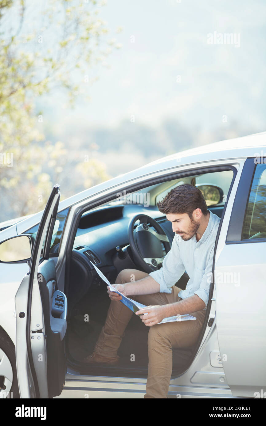Man in car looking at map Stock Photo