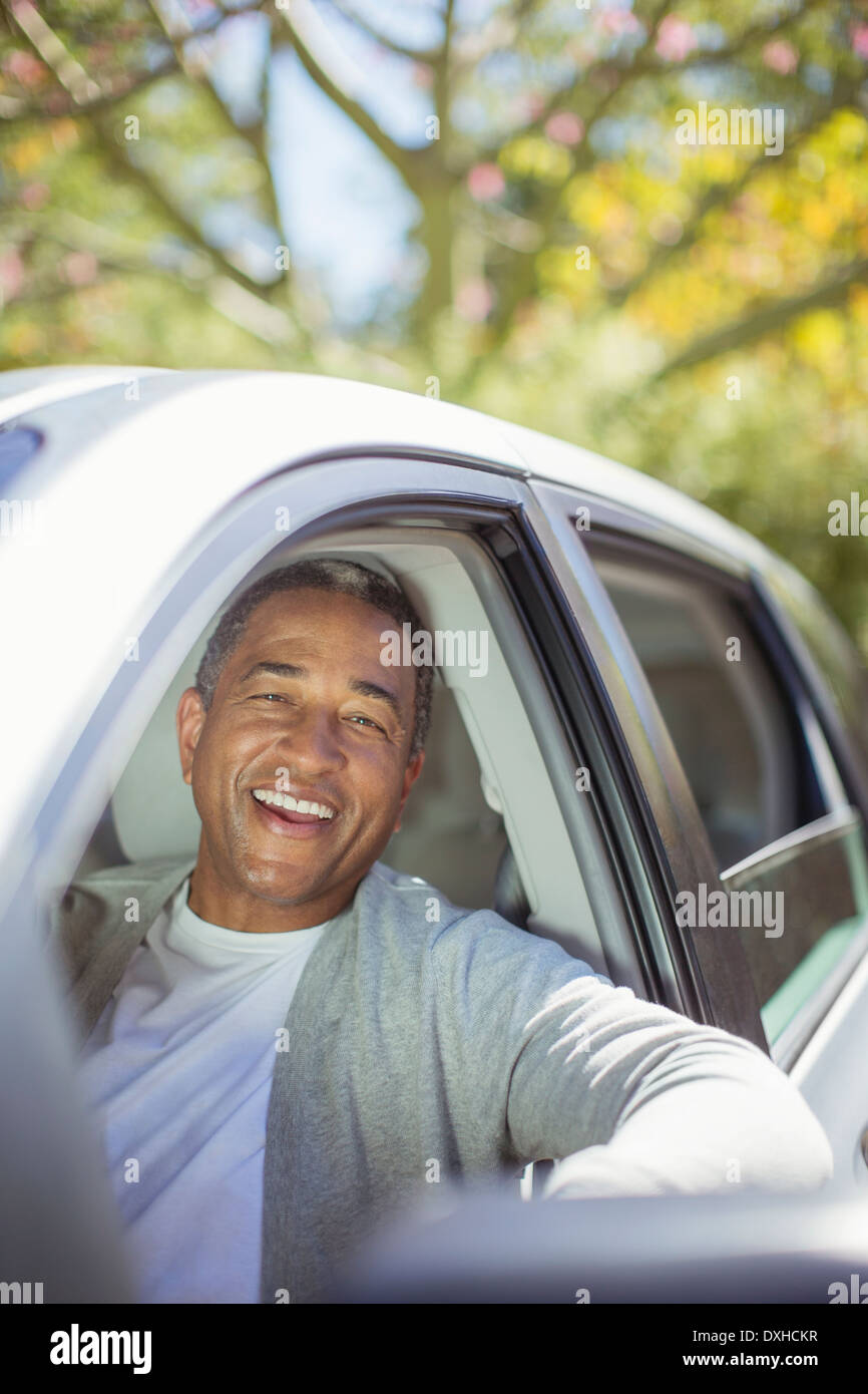 Portrait of senior man laughing in car Stock Photo