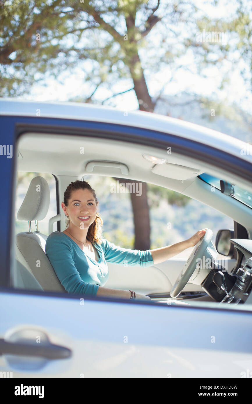 Portrait of smiling woman inside car Stock Photo