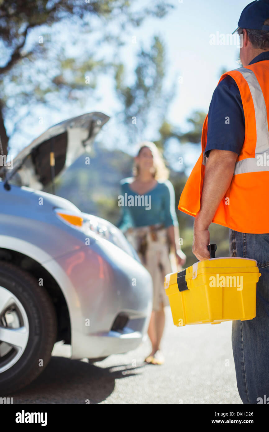 Roadside mechanic arriving to help woman Stock Photo