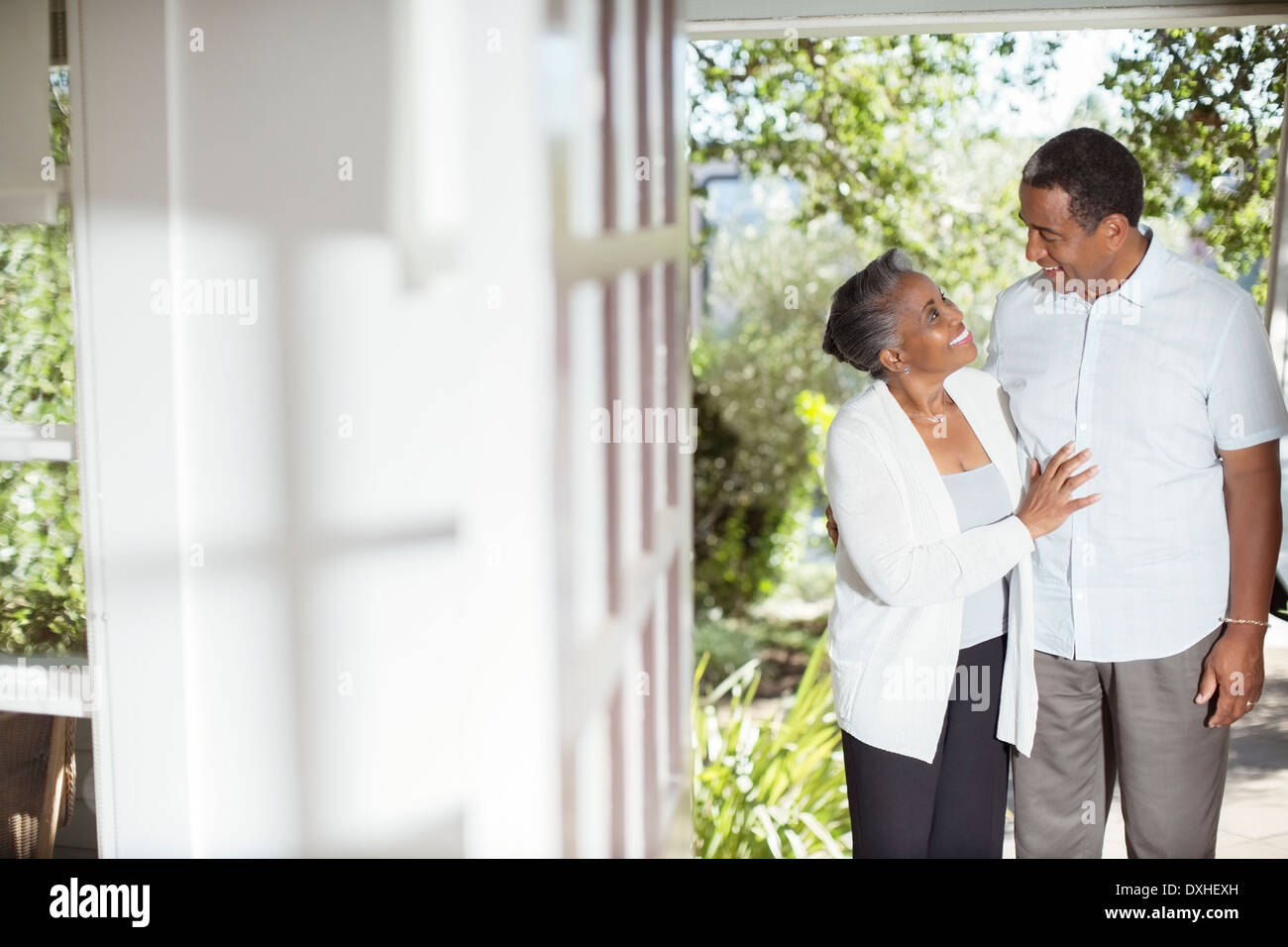 Senior couple hugging on patio Stock Photo
