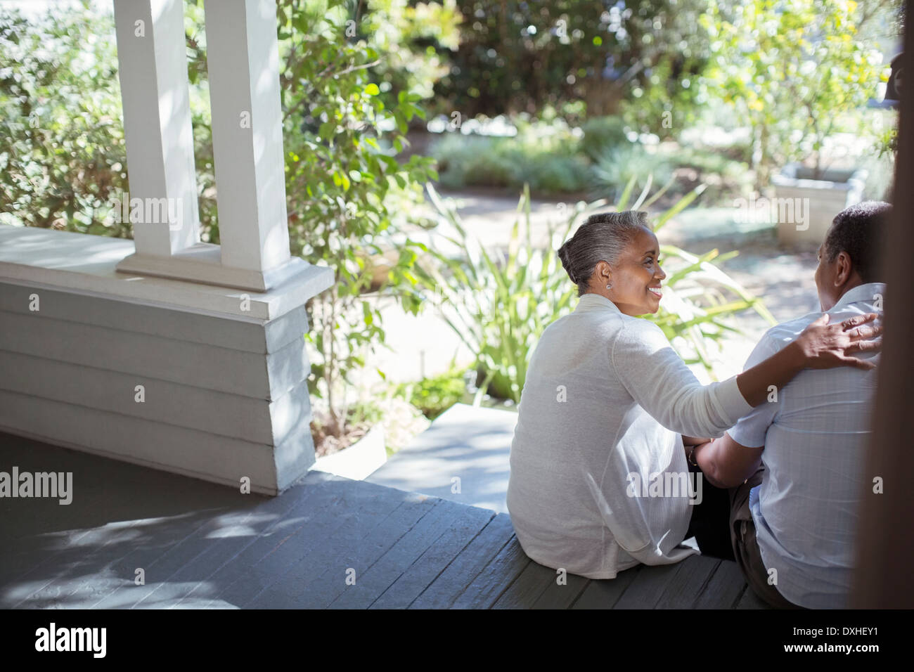 Senior couple hugging on porch Stock Photo