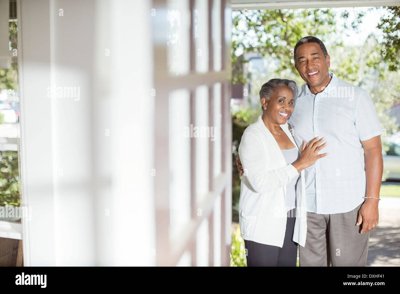 Portrait of smiling senior couple in doorway Stock Photo