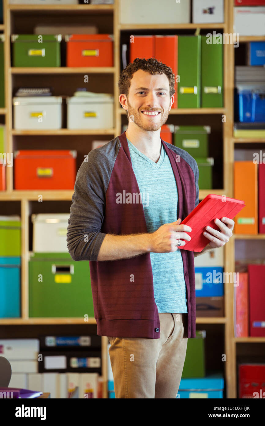 Portrait of confident creative businessman holding digital tablet Stock Photo