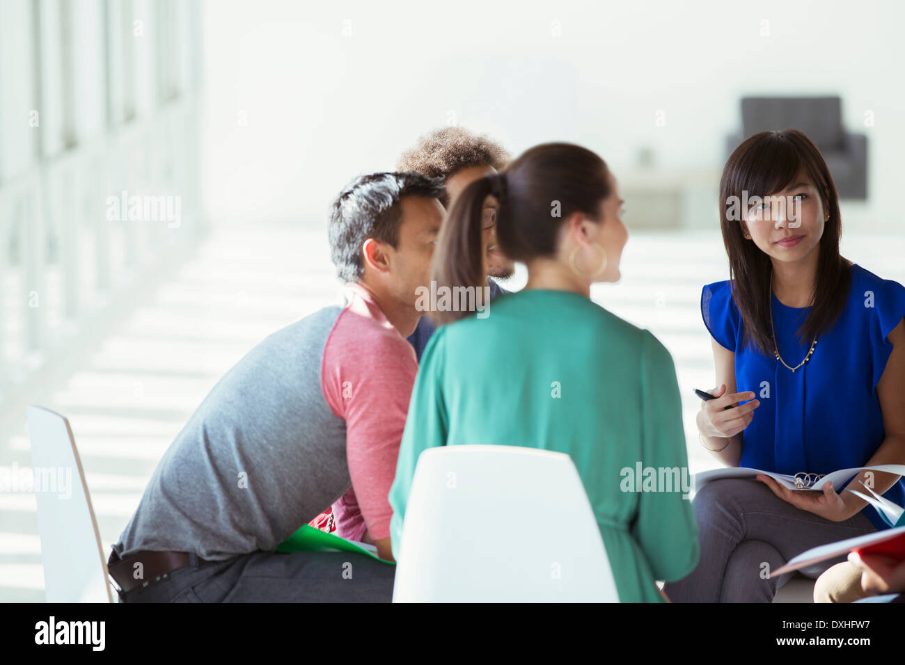 Creative business people meeting in circle of chairs Stock Photo