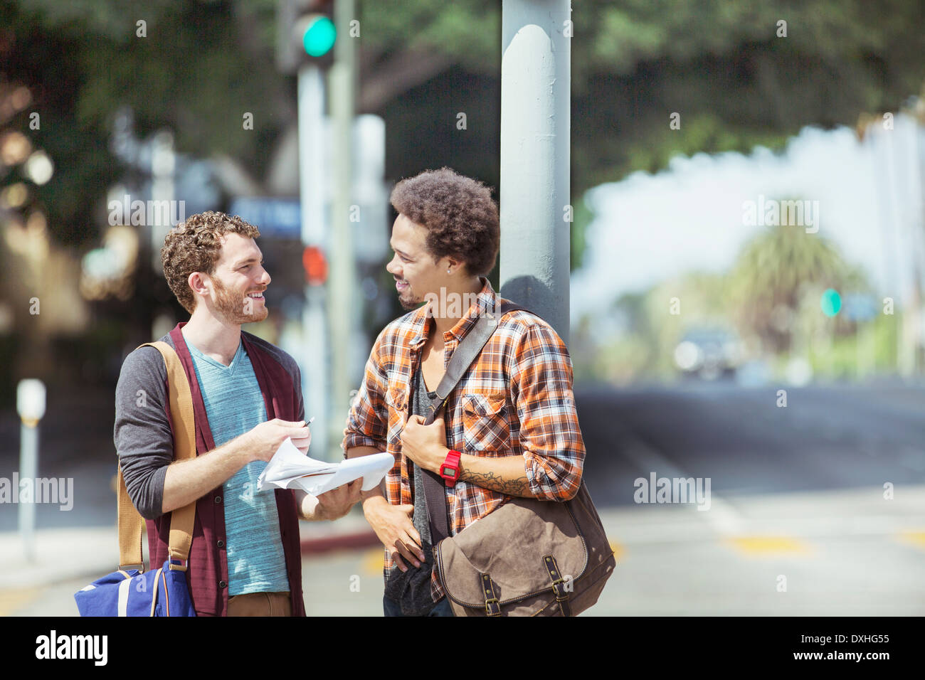 Businessmen with paperwork on urban street Stock Photo