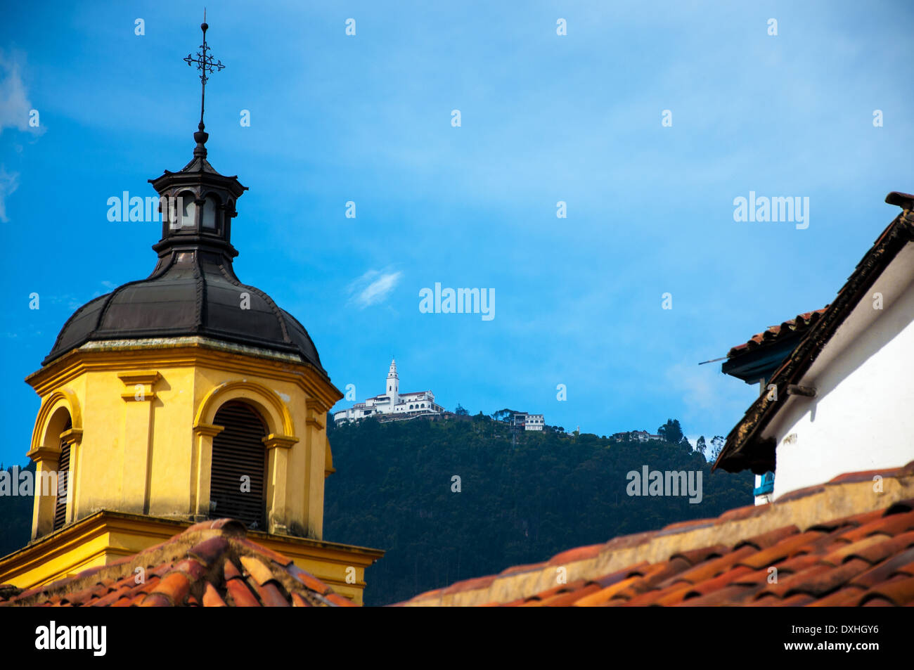 A yellow church in Bogota with Monserrate in the background. Stock Photo
