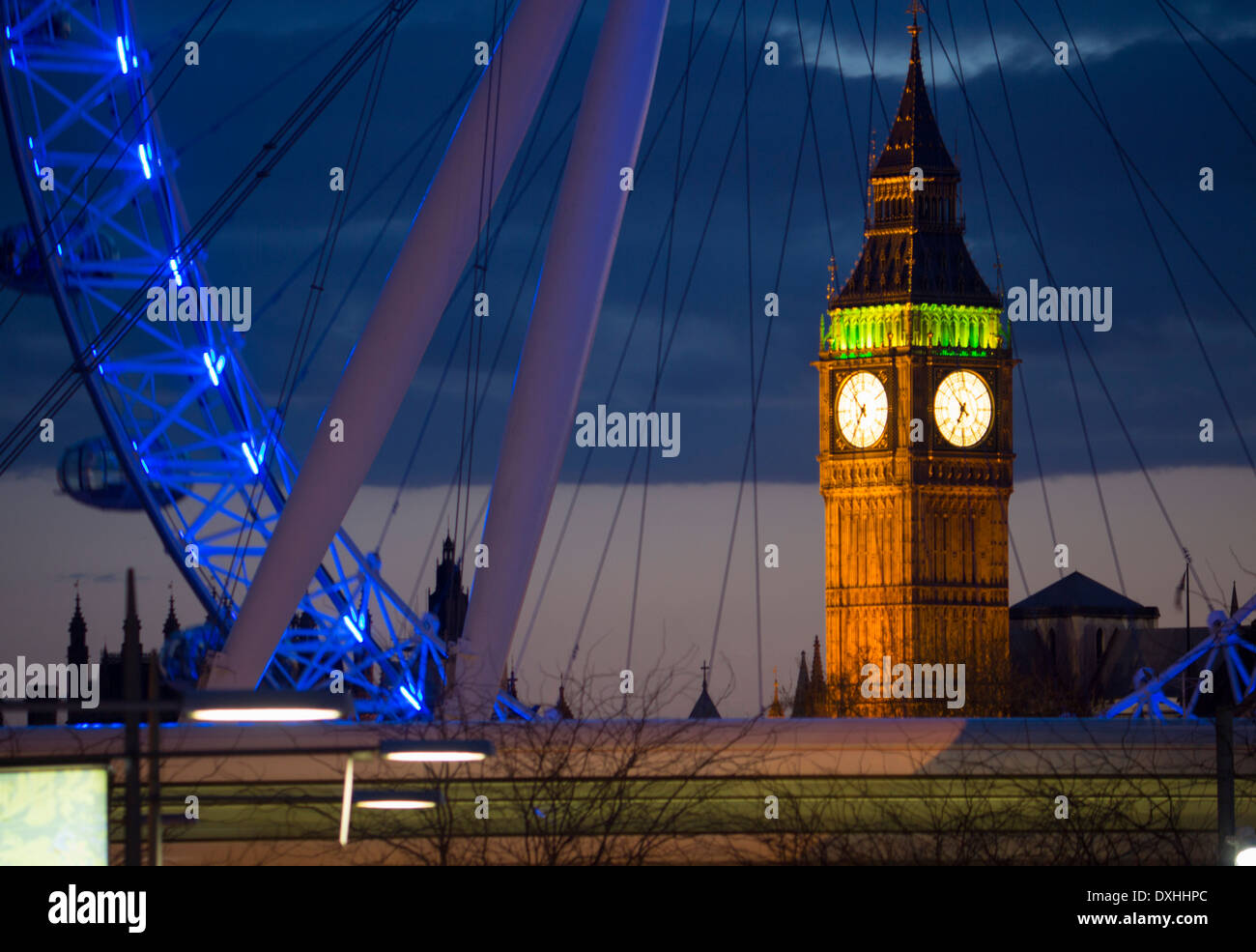 Big Ben Clock Tower of Houses of Parliament and Millennium Wheel or London Eye at dusk London England UK Stock Photo
