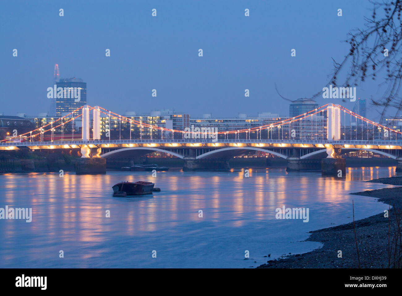 Chelsea Bridge and River Thames at night dusk twilight The Shard in distance to left London England UK Stock Photo