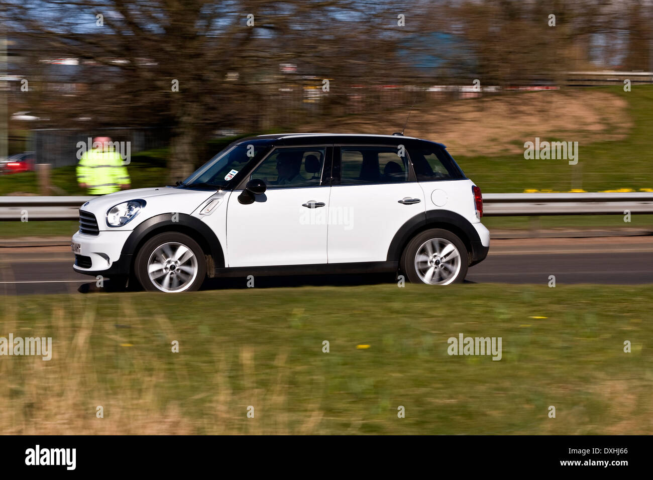 Panning a Mini Clubman car without rear sync flash travelling along the Kingsway West Dual Carriageway in Dundee, UK Stock Photo