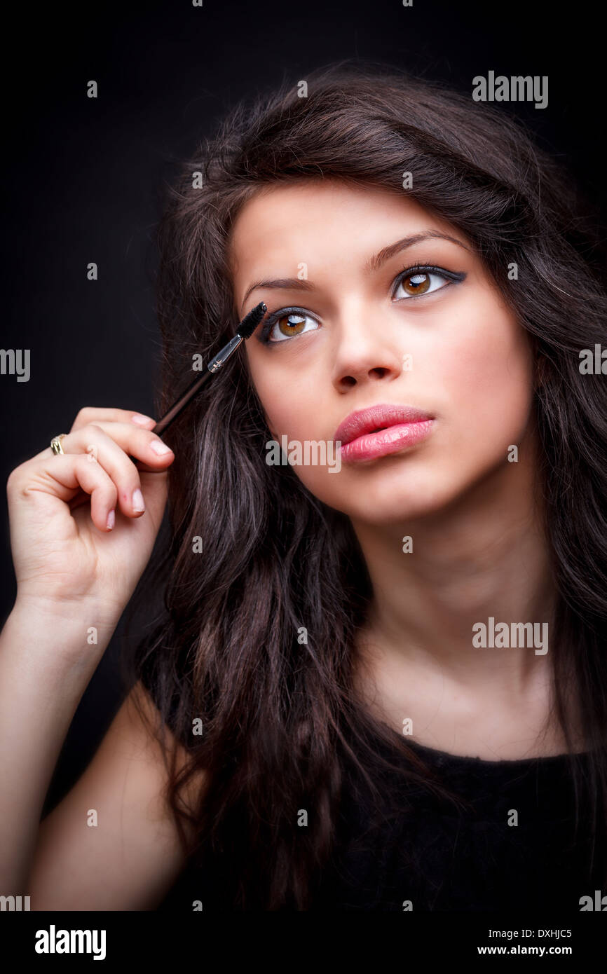 Eyes make-up, girl applying mascara Stock Photo