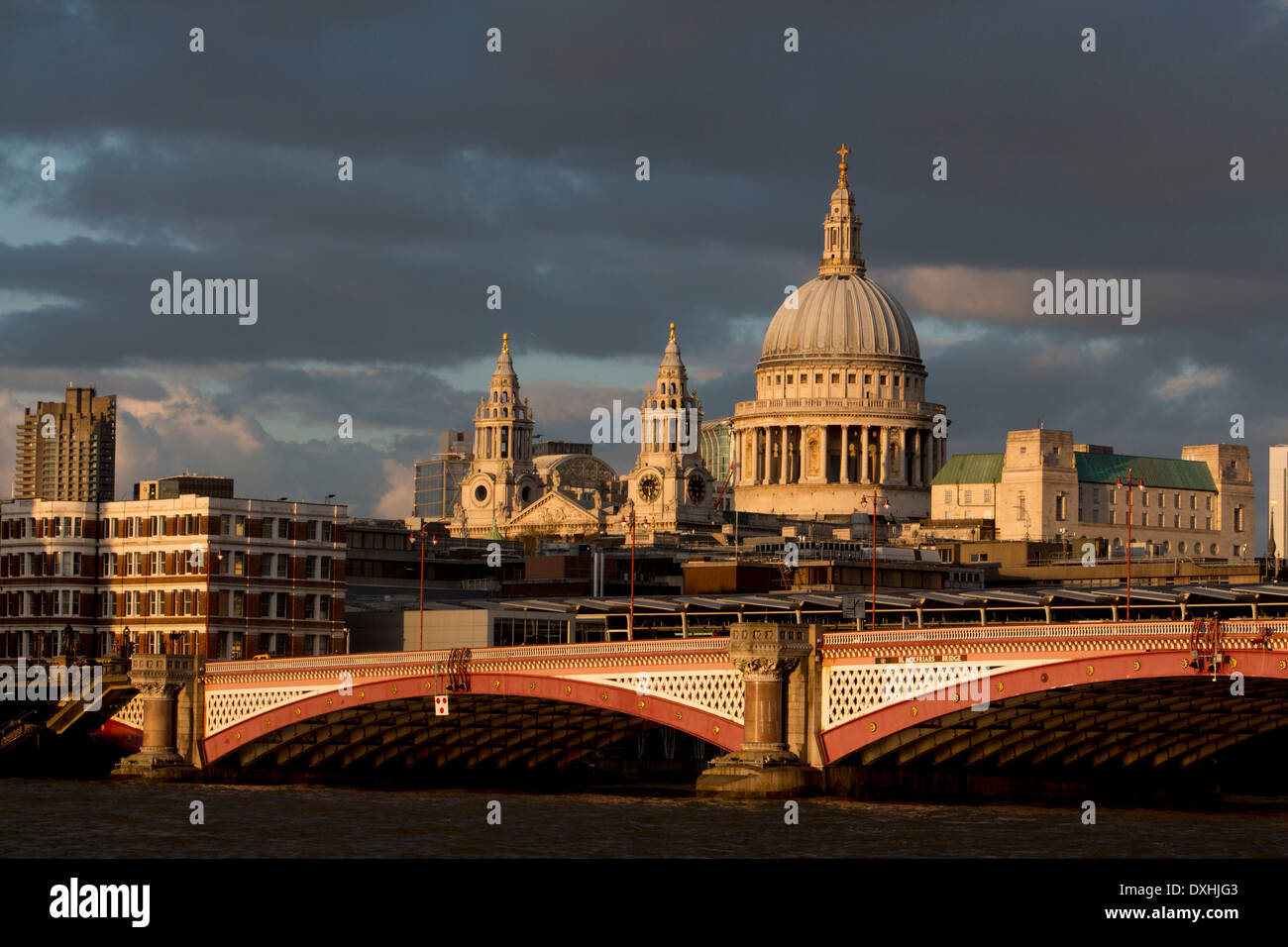St Paul's Cathedral from South Bank looking across River Thames to Blackfriars Bridge with dramatic dark sky London England UK Stock Photo