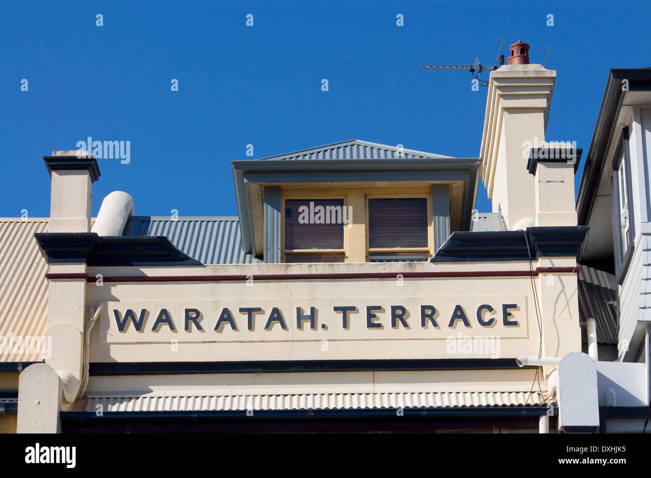 Traditional stone house with painted street sign 'Waratah Terrace