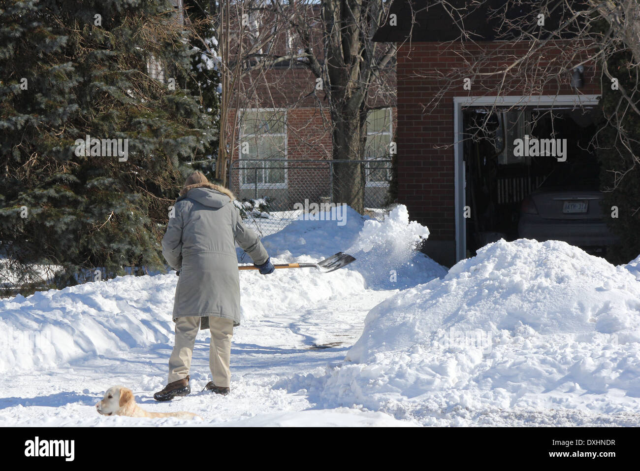 An unidentified person shoveling snow off his driveway after a snowfall