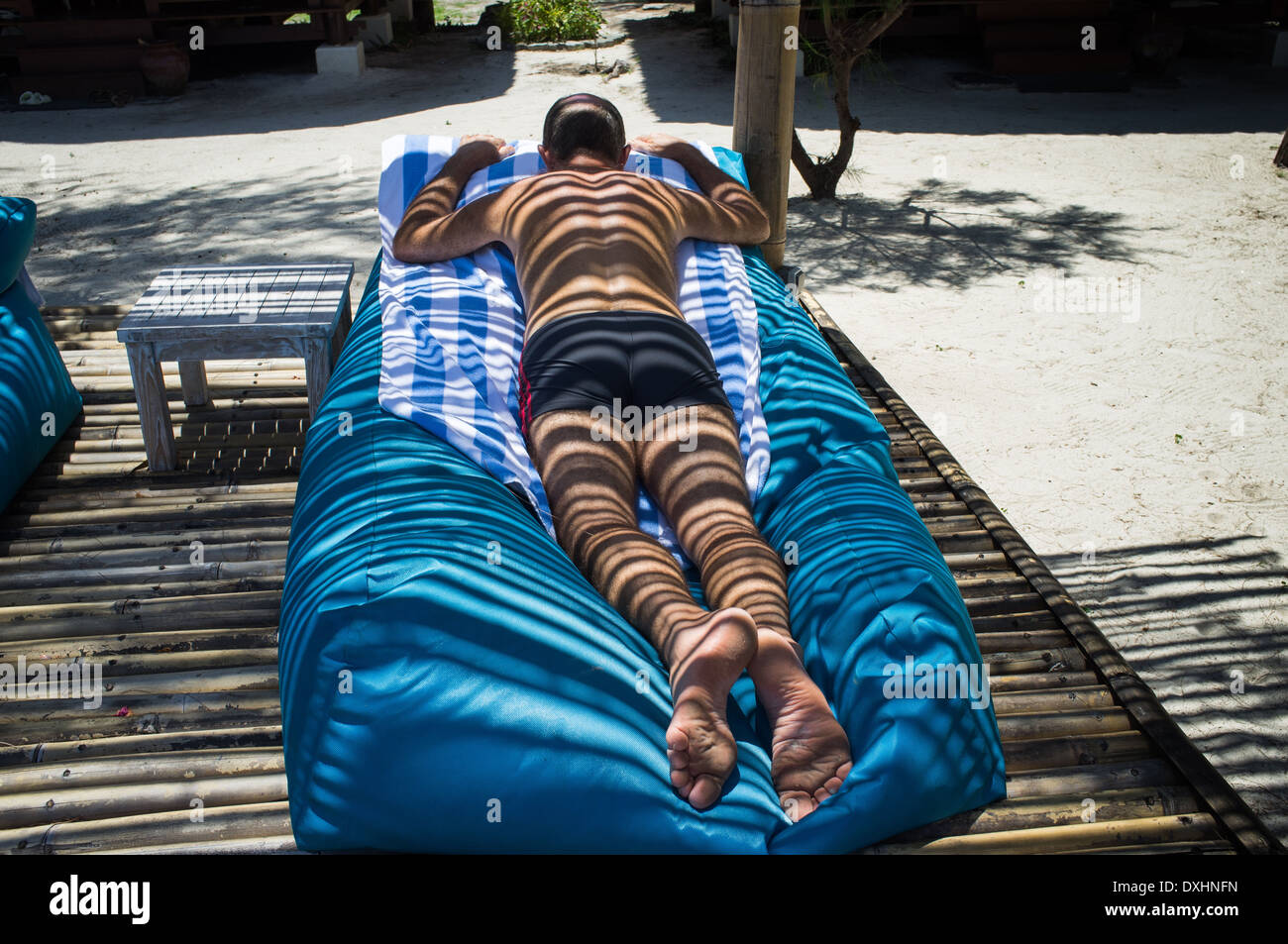 Man bask in the sun loungers, Gili Meno island, Lombok, Indonesia, Asia Stock Photo