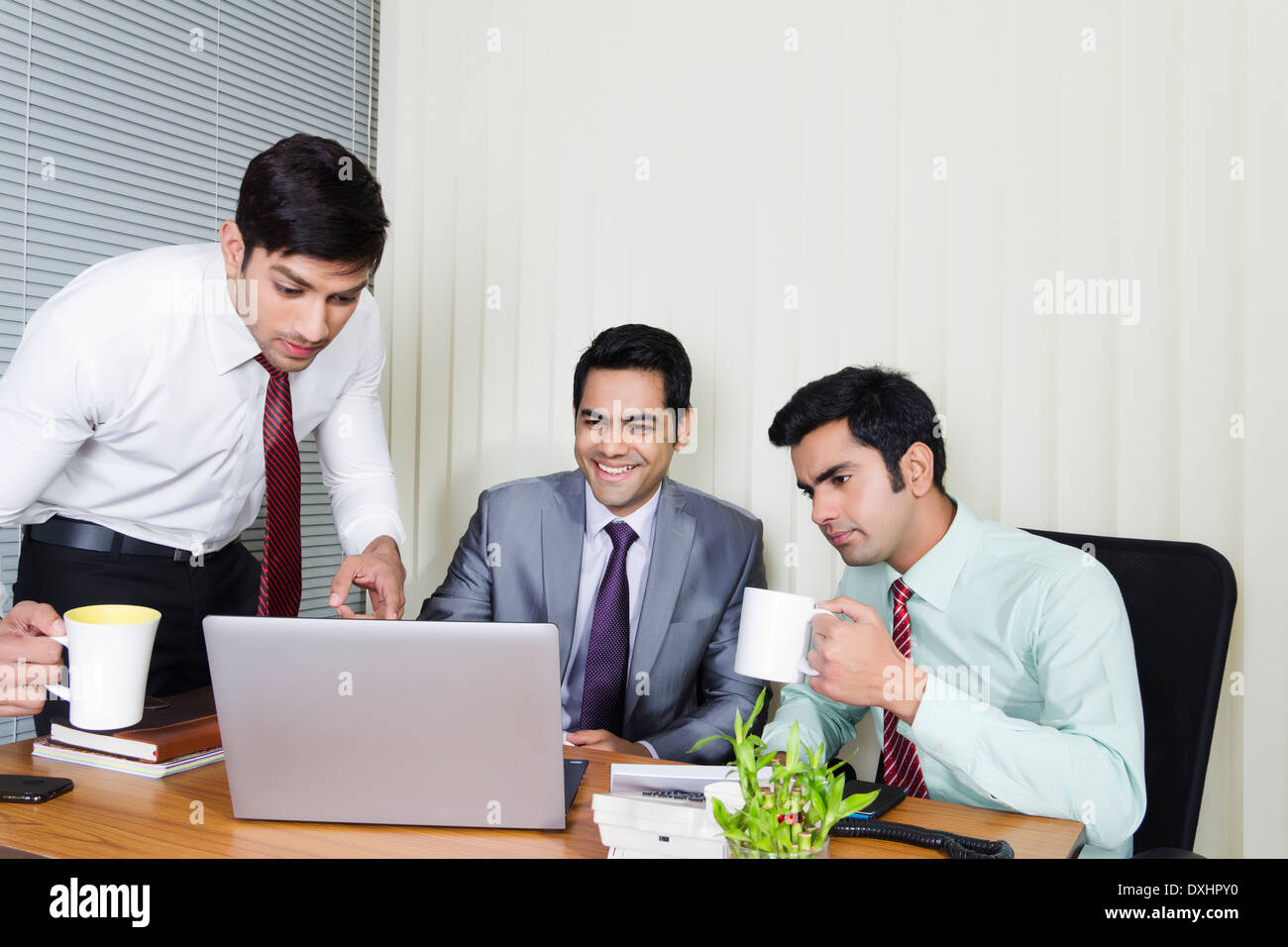 Indian Businessman sitting in Office and Disscussing Stock Photo