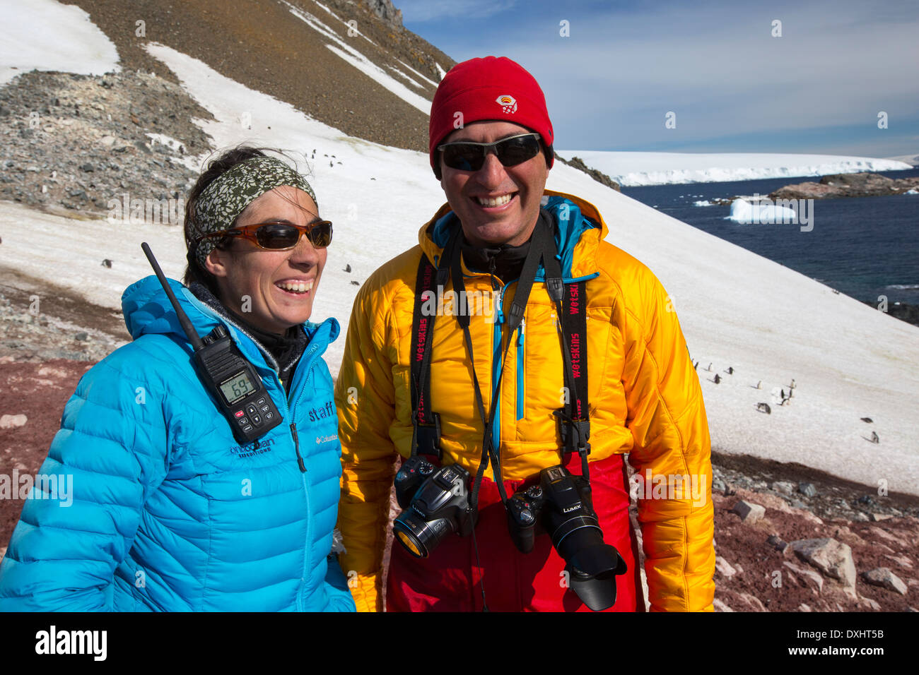 A man and woman from an expedition cruise on Joinville Island just off the Antarctic Peninsular. Stock Photo