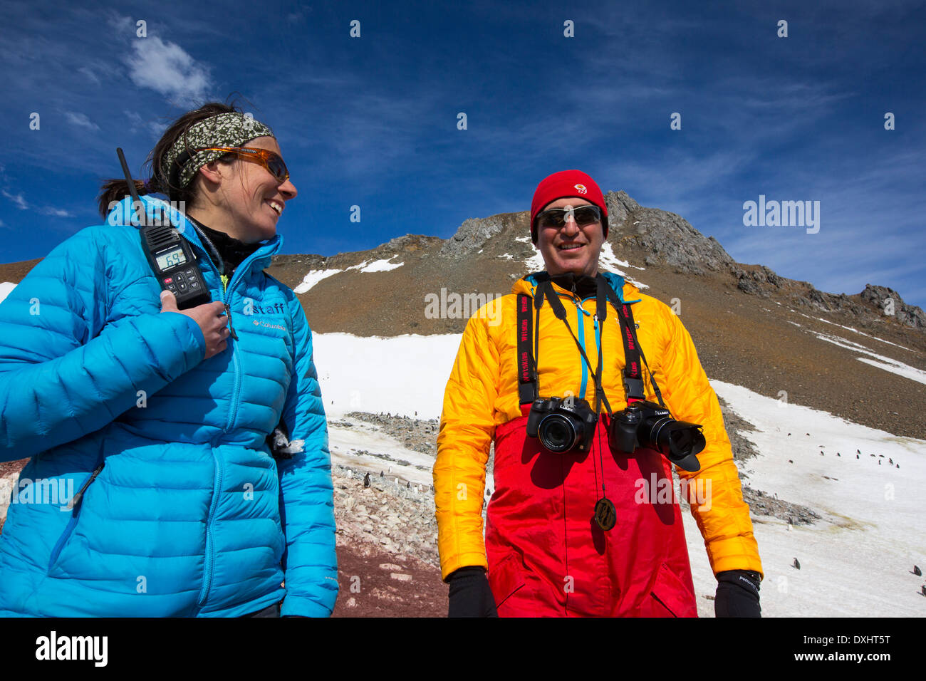 A man and woman from an expedition cruise on Joinville Island just off the Antarctic Peninsular. Stock Photo