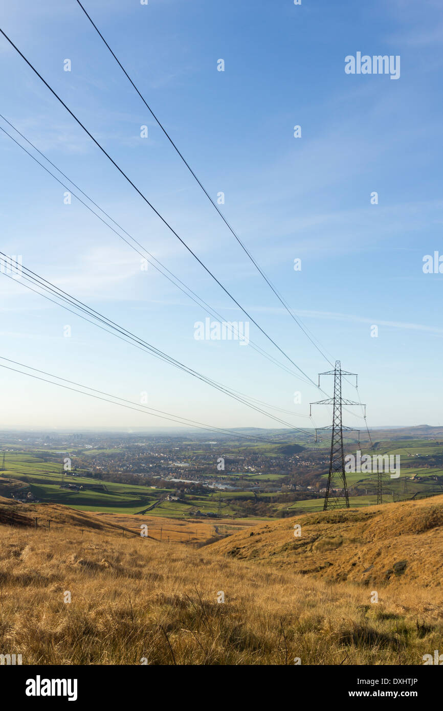 Electricity pylons carrying part of the National Grid over Blackstone Edge and down into the Roch valley towards Littleborough. Stock Photo
