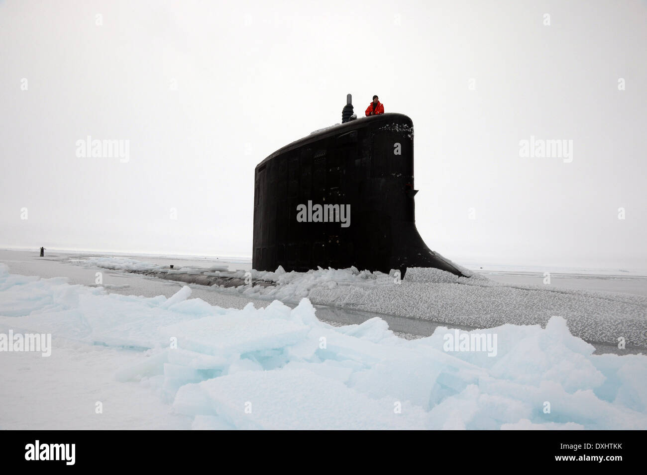 US Navy Virginia-class nuclear attack submarine USS New Mexico surfaces through the arctic ice during training exercise ICEX 2014 March 22, 2014 off the coast of Alaska. Stock Photo