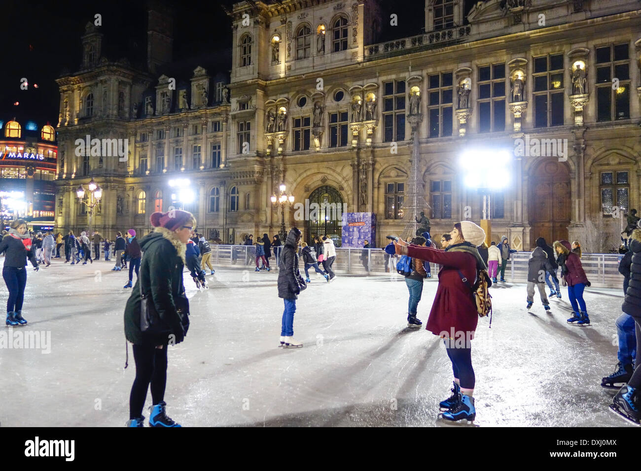Ice skaters on the rink in front of the Hotel de Ville, Paris, France