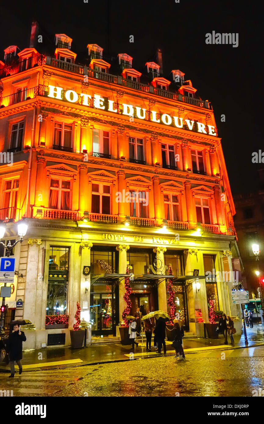 Exterior of the Hotel du Louvre on a rainy winter's evening, Paris, France Stock Photo