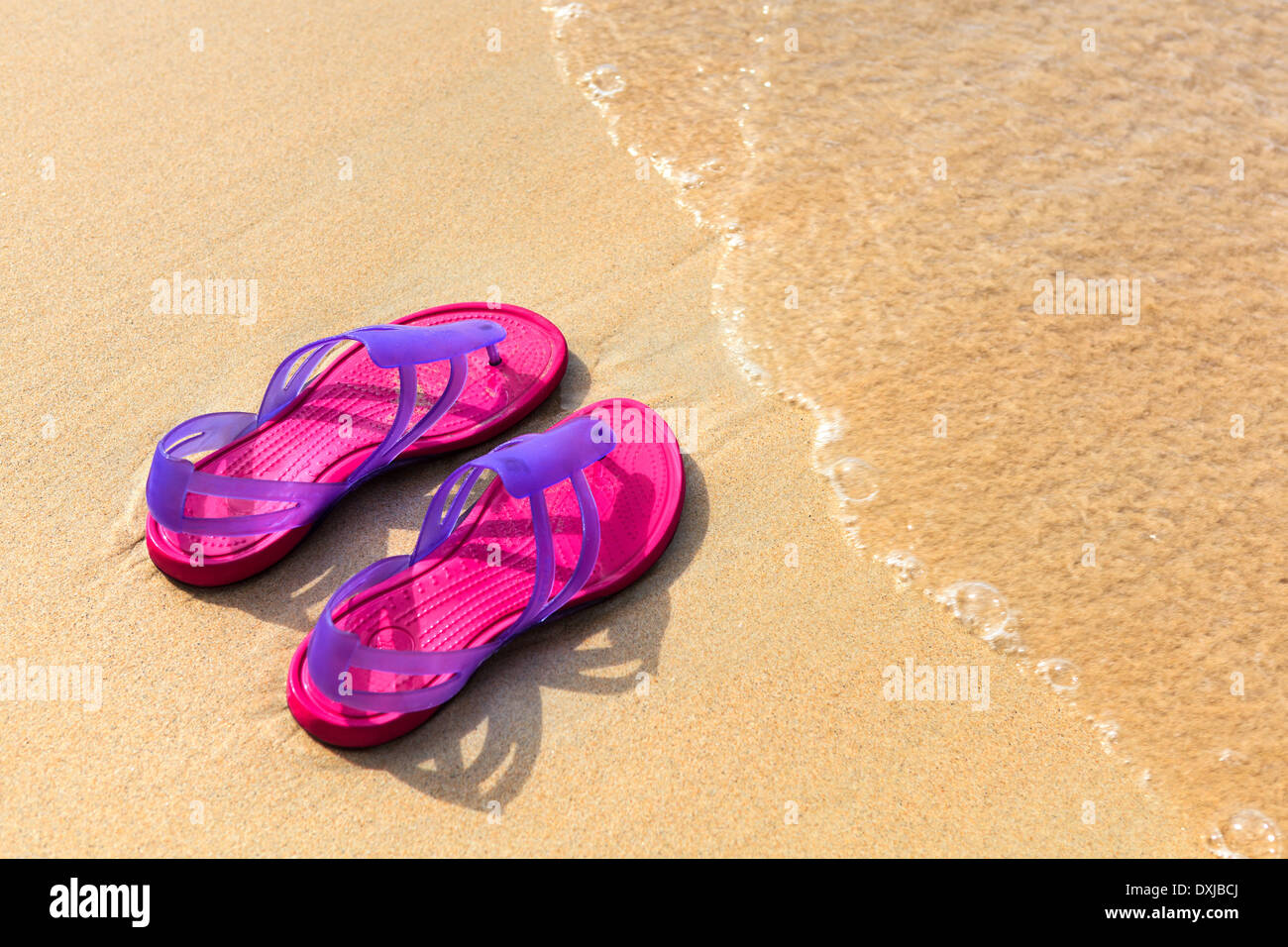 Sandals on the beach - concept image Stock Photo - Alamy