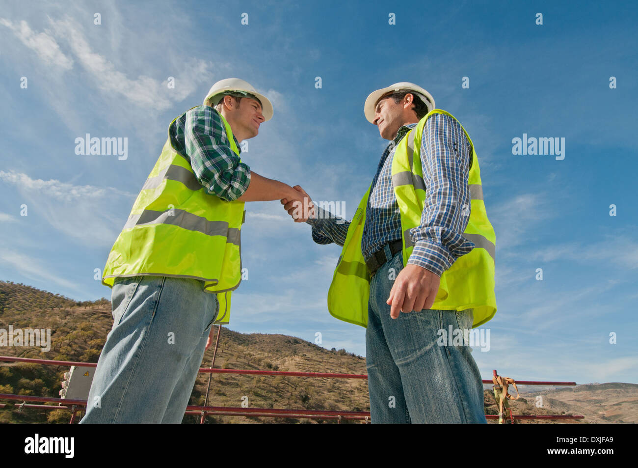 Two construction engineers shaking hands Stock Photo