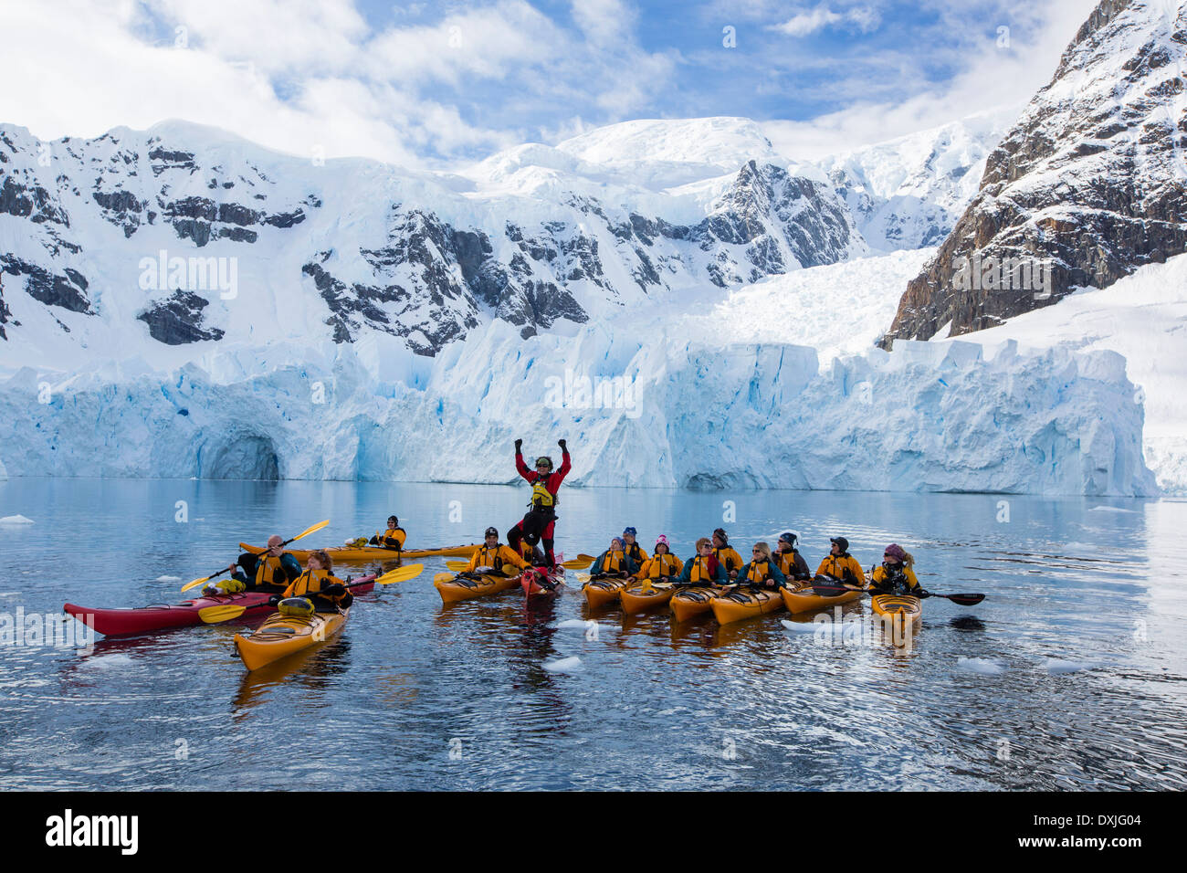 Members of an expedition cruise to Antarctica sea kayaking in Paradise Bay beneath Mount Walker on the Antarctic Peninsular. Stock Photo