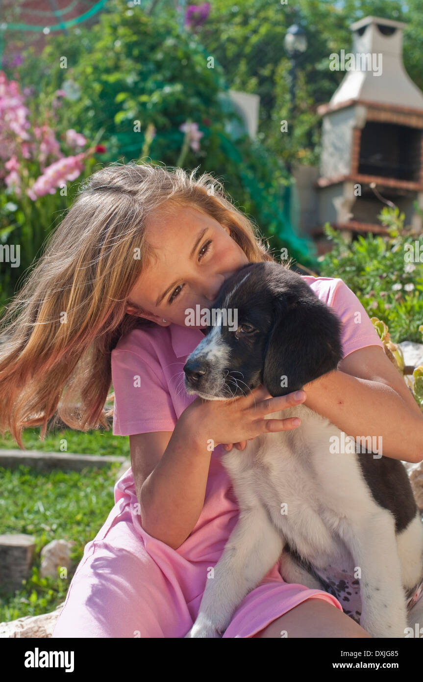 young girl with dog in garden Stock Photo - Alamy