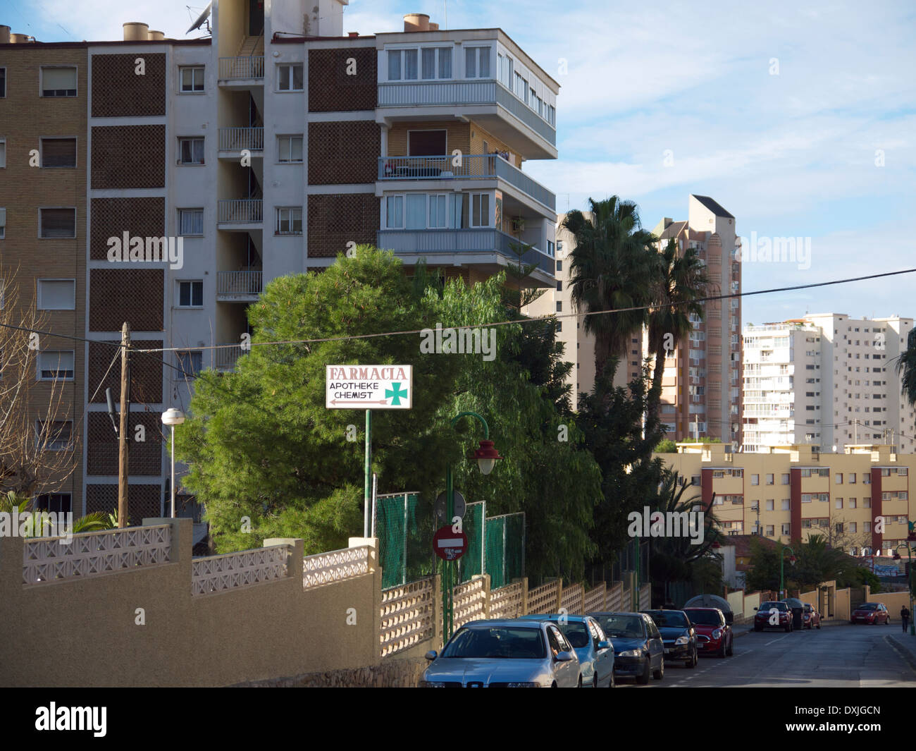 Typical street scene in Benidorm, Spain showing a pharmacy sign. Stock Photo