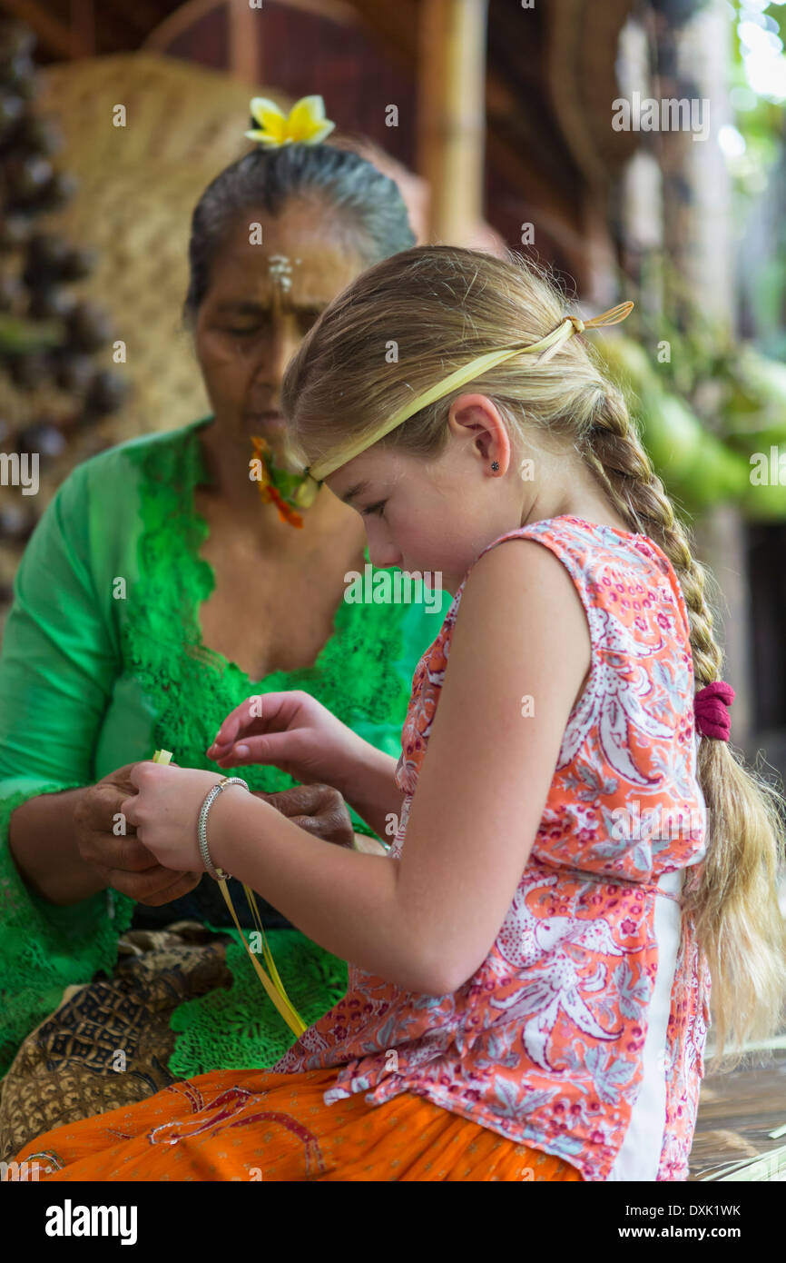 Girl learning Balinese weaving, Ubud, Bali, Indonesia Stock Photo