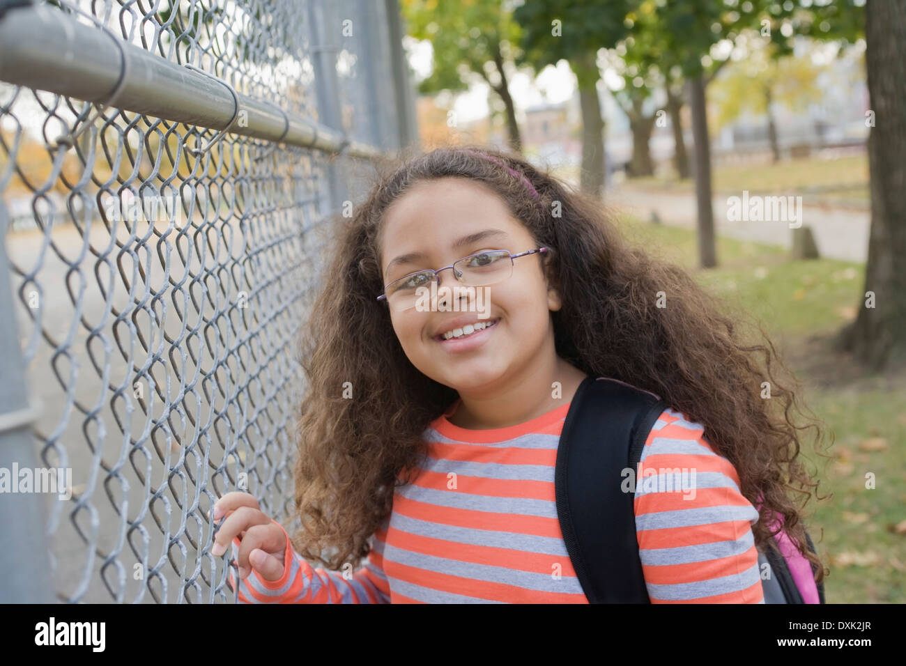 Portrait of Hispanic school girl at fence Stock Photo Alamy