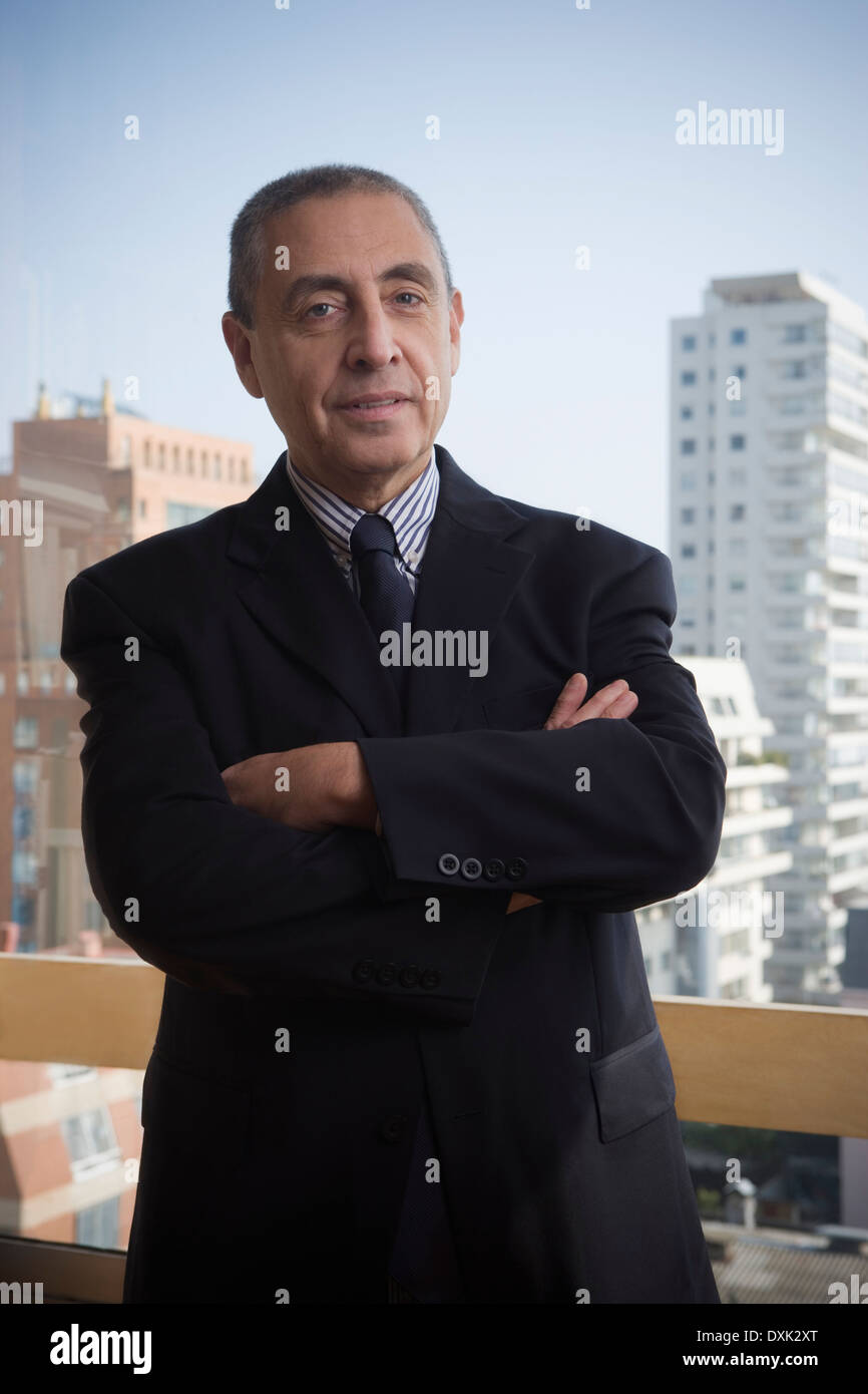 Portrait of confident Hispanic businessman in urban office Stock Photo
