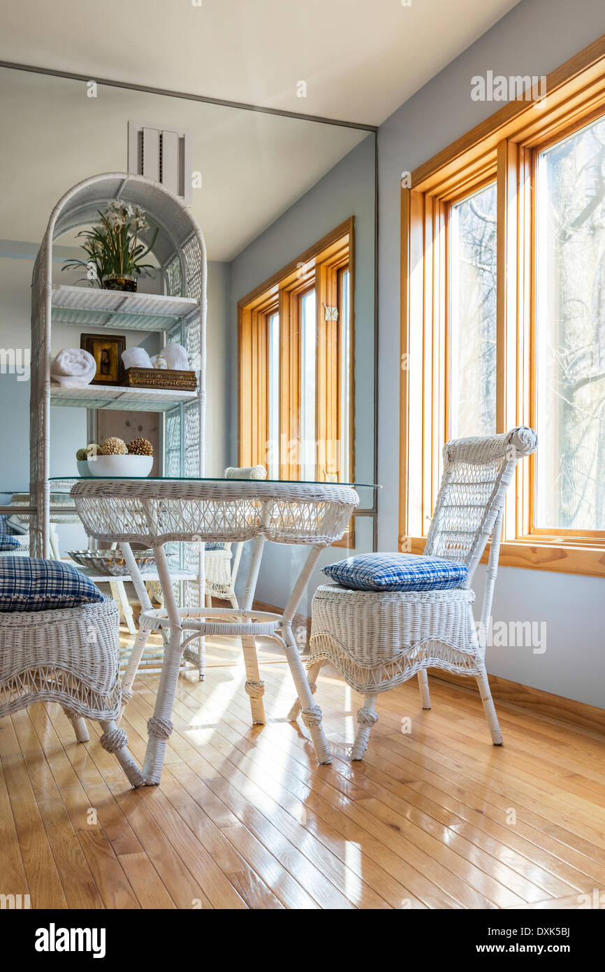 Wicker chairs and table in dining room Stock Photo
