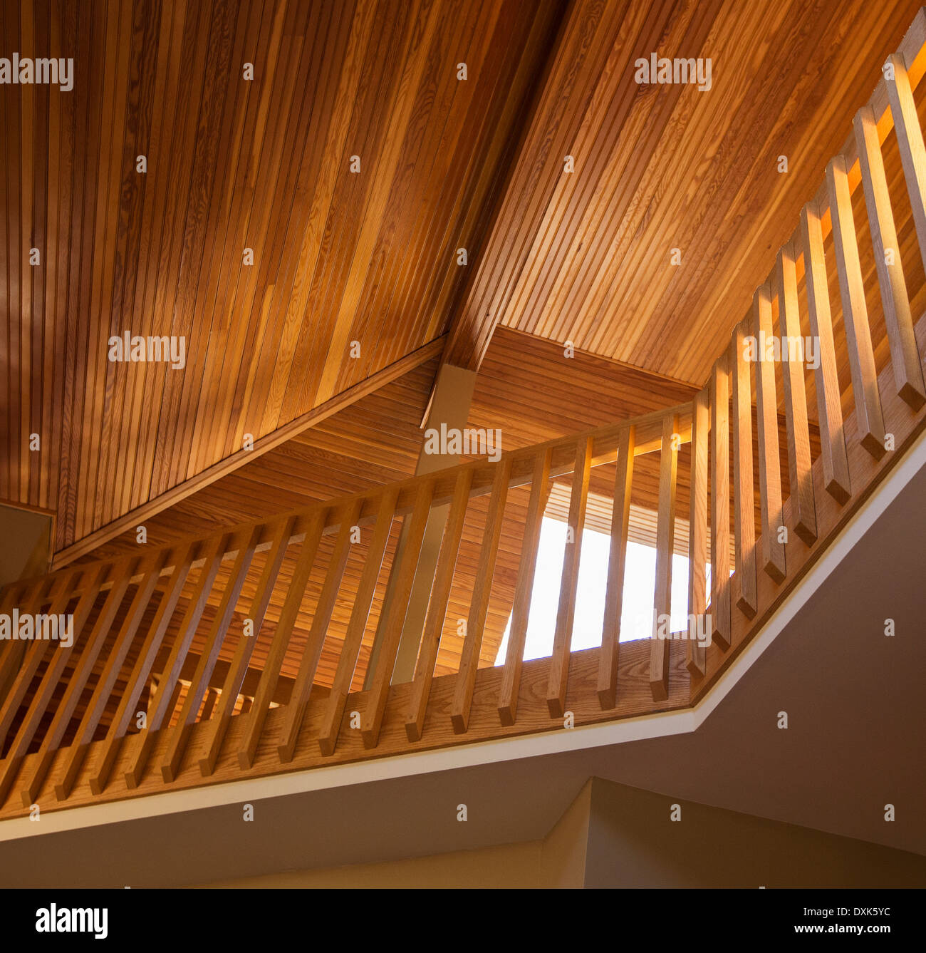 Slanted wooden ceiling above railing in house Stock Photo
