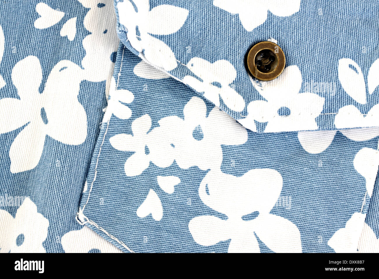 White flower pattern on blue fabric pocket for the background. Stock Photo
