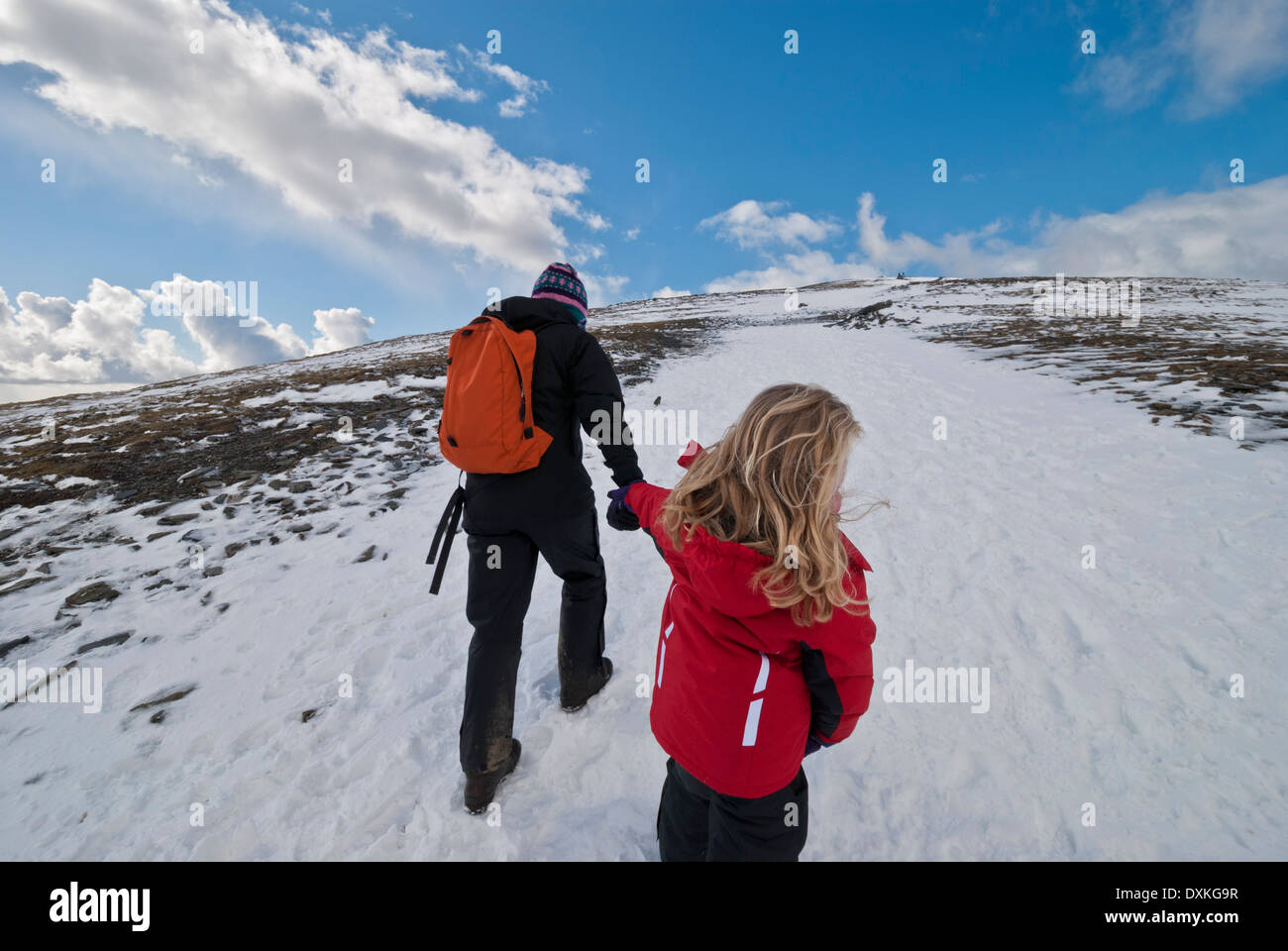 Lady walker and child walking towards Skiddaw summit. Stock Photo