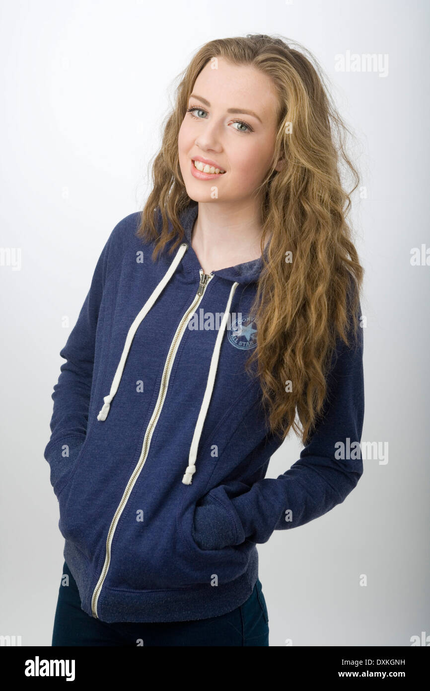 Portrait of a pretty teenage girl wearing a hooded sweatshirt. Stock Photo