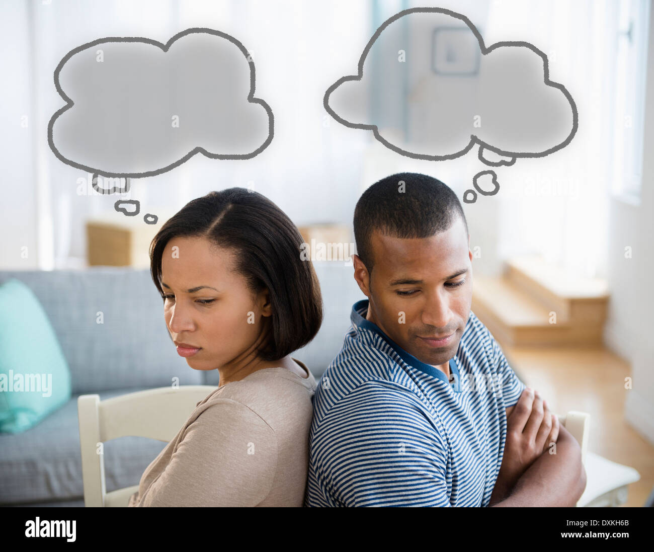 Thought bubbles above frustrated couple Stock Photo