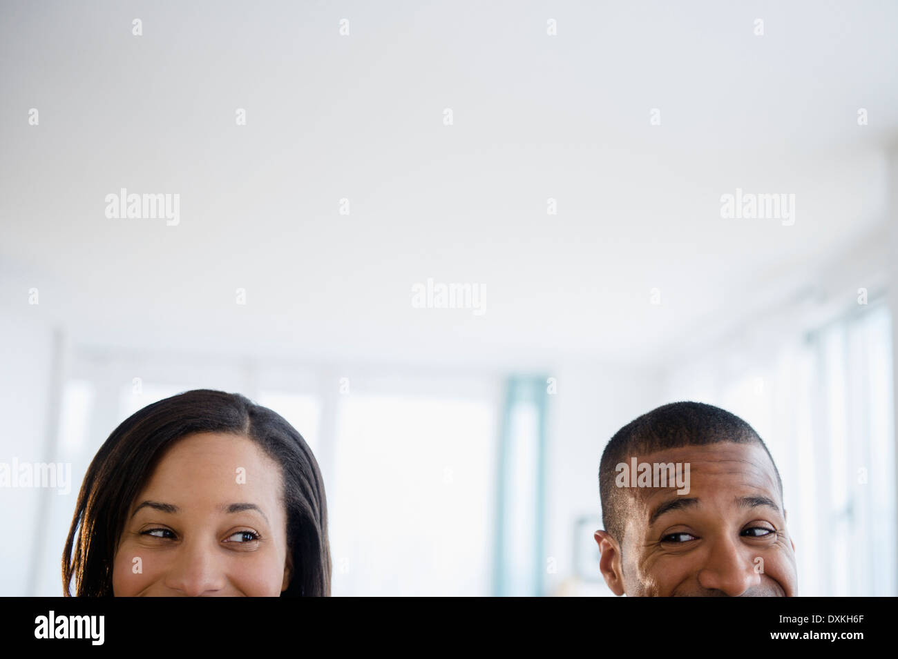 Couple engaged in sideways glance Stock Photo