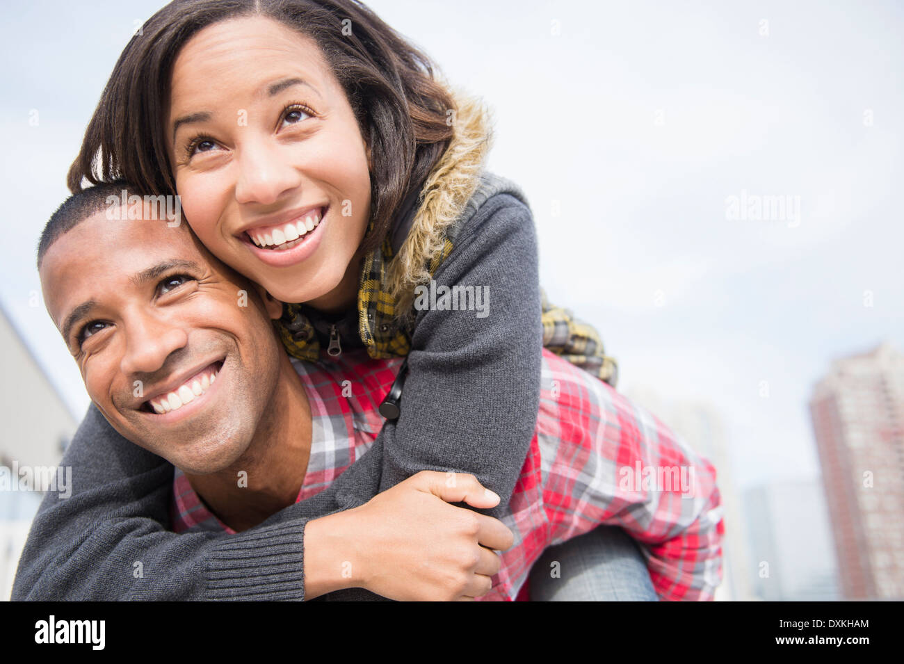Happy couple piggybacking Stock Photo
