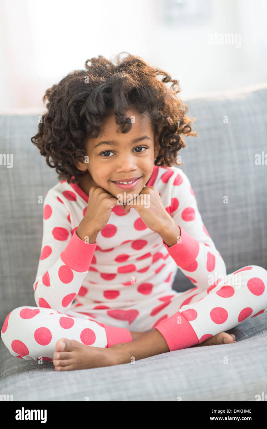 Portrait of smiling African American girl in pajamas Stock Photo