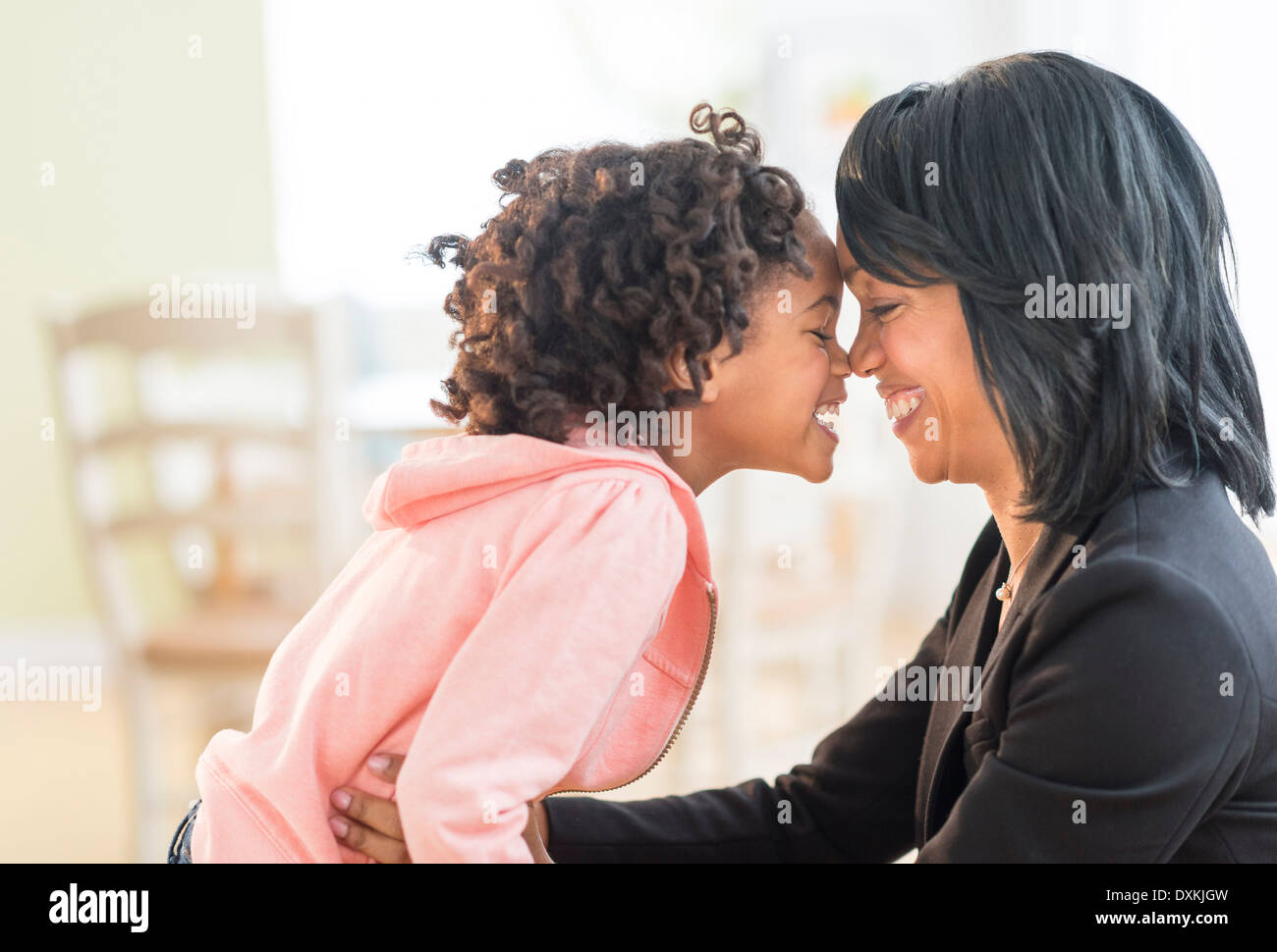 Black mother and daughter rubbing noses Stock Photo