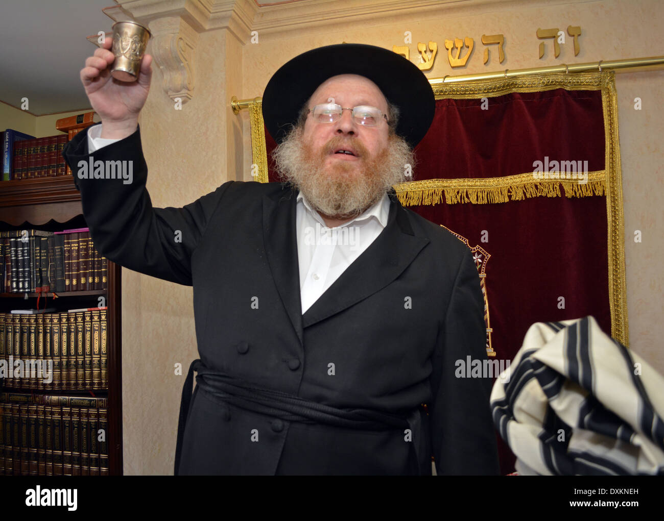 Religious Jewish grandfather toasting at a bris ceremony in a 