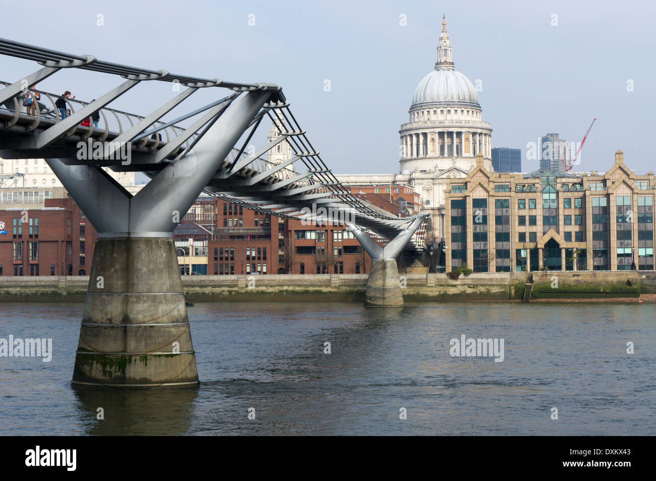 The Millennium Footbridge crossing the River Thames from the South Bank towards the dome of St Paul's Cathedral. Stock Photo