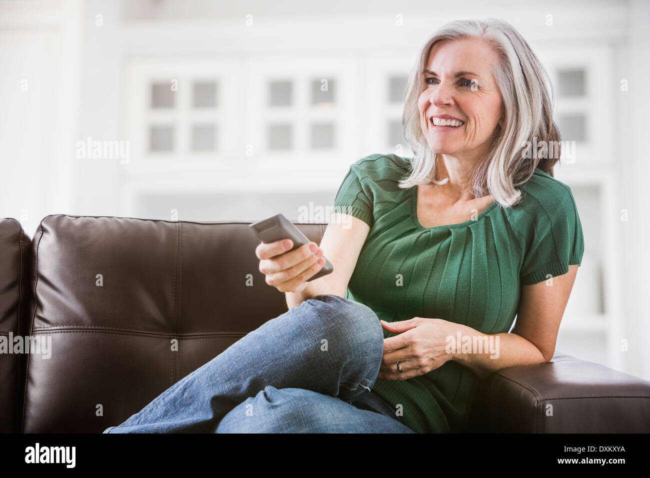 Woman happy watching tv hi-res stock photography and images - Alamy