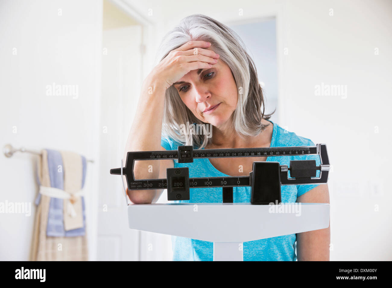 Woman hugging weight scale hi-res stock photography and images - Alamy